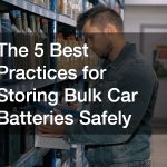 man reaching for a new car battery on a shelf